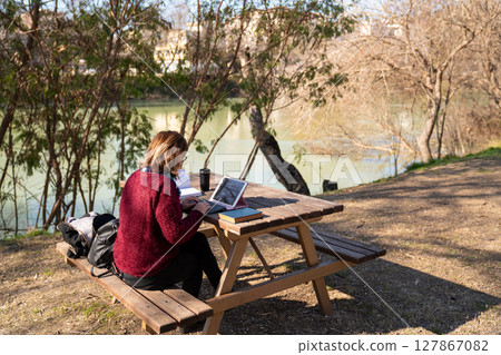 Remote Work in Nature. A Peaceful Outdoor Workspace by the River Remote Work in Nature. A Peaceful Outdoor Workspace by the River 127867082