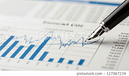 Financial Analysis Pen Pointing at Stock Market Bar Graph and Line Chart with Numbers 127867239