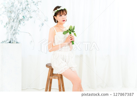 Woman in a bustier holding a bouquet 127867387