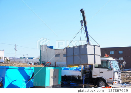 Lifting materials with a truck equipped with a crane 127867629