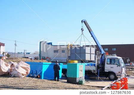 Lifting materials with a truck equipped with a crane 127867630