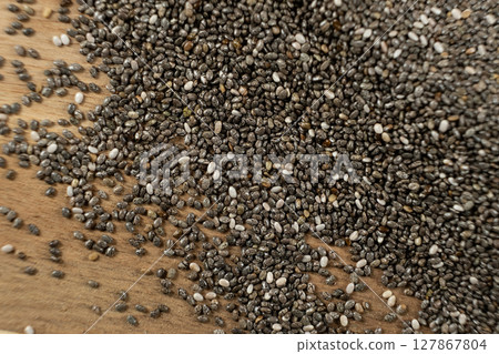 Pile of raw chia seeds on wooden background, natural superfood, space for text. 127867804
