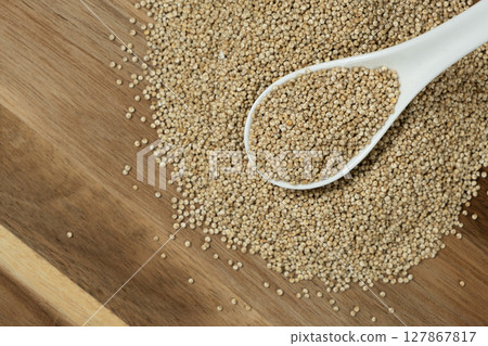 Natural white quinoa in a spoon top view 127867817
