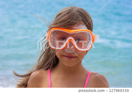 Portrait of caucasian child of 7-8 years in swimming mask looking at camera Portrait of caucasian child of 7-8 years in swimming mask looking at camera 127868330