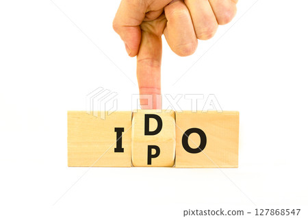 Initial public or DEX offering symbol. Concept words abbreviation IPO or IDO on wooden block. Beautiful white table white background. Business Initial public or DEX offering concept. Copy space. 127868547