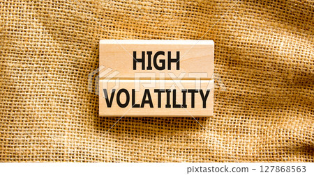 High volatility symbol. Concept words High volatility on beautiful wooden blocks. Beautiful canvas table canvas background. Business high volatility concept. Copy space. 127868563