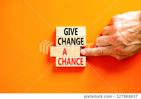 Give change a chance symbol. Concept words phrase Give change a chance on beautiful wooden blocks. Beautiful orange paper background Businessman's hand Business Give change a chance concept Copy space Give change a chance symbol. Concept words phrase Give change a chance on beautiful wooden blocks. Beautiful orange paper background Businessman's hand Business Give change a chance concept Copy space 127868637