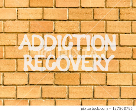 Addiction recovery symbol. Concept words Addiction recovery on beautiful brick wall. Beautiful brick wall background. Psychology addiction recovery concept. Copy space. Addiction recovery symbol. Concept words Addiction recovery on beautiful brick wall. Beautiful brick wall background. Psychology addiction recovery concept. Copy space. 127868795