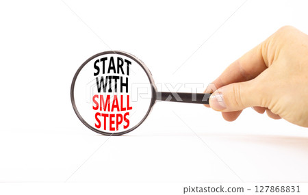 Start with small steps symbol. Concept words phrase Start with small steps in beautiful black magnifying glass. Beautiful white background. Business Start with small steps concept. Copy space. Start with small steps symbol. Concept words phrase Start with small steps in beautiful black magnifying glass. Beautiful white background. Business Start with small steps concept. Copy space. 127868831