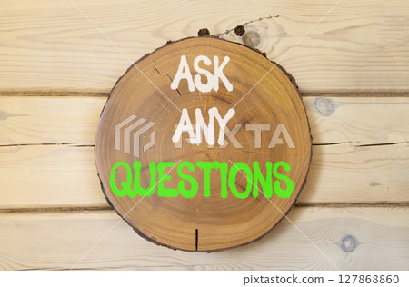 Ask any questions symbol. Concept words Ask any questions on beautiful wooden circle. Beautiful wooden wall wooden background. Business ask any questions concept. Copy space. 127868860