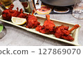 close up of Indian Tandoori chicken on a plate. A traditional dish made with marinated in yogurt and spices, roasted in a tandoor oven 127869070
