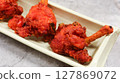 close up of Indian Tandoori chicken on a plate. A traditional dish made with marinated in yogurt and spices, roasted in a tandoor oven 127869072