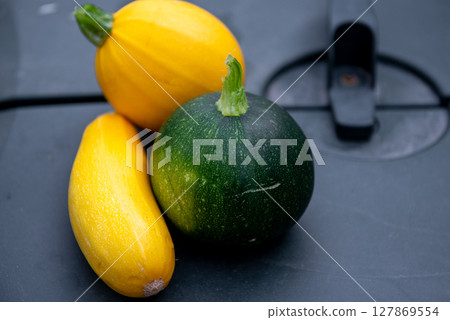 fresh vegetables. one yellow round, one yellow long and one green round zucchini. fresh vegetables. one yellow round, one yellow long and one green round zucchini. 127869554