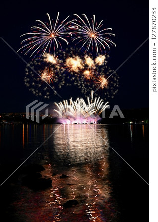 Beautiful colorful fireworks with reflections in water. Brno dam, the city of Brno-Europe. International Fireworks Competition. 127870233