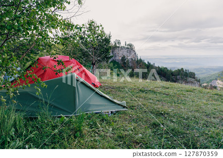 Camping with a tents in the mountains, hiking in summer Camping with a tents in the mountains, hiking in summer 127870359