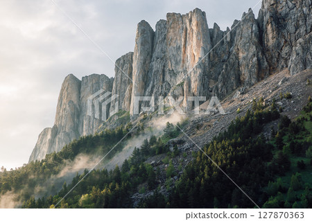 Bolshoy Tkhach mountain with rocks, fog and sunlight. Caucasus Mountains. 127870363