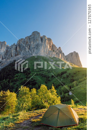 Camping spot in the mountains with a tent at sunrise, Bolshoy Tkhach national park in Caucasus 127870365