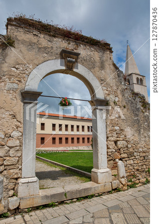 Ancient stone archway gate, medieval architecture in Porec, Croatia. 127870436