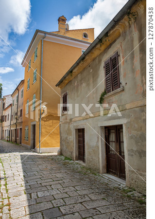 Historic cobblestone street in mediterranean old town Porec, Croatia. 127870438