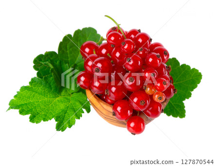 Red currant isolated on white background. Redcurrant or Ribes rubrum ripe berries with green leaves in wooden bowl. 127870544
