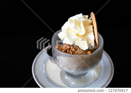 Cup of ice cream with crumble nuts and whipped cream in Keerbergen, Flemish Brabant, Belgium Cup of ice cream with crumble nuts and whipped cream in Keerbergen, Flemish Brabant, Belgium 127870917