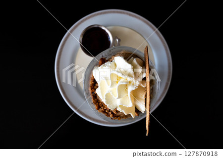 Cup of ice cream with crumble nuts and whipped cream in Keerbergen, Flemish Brabant, Belgium 127870918
