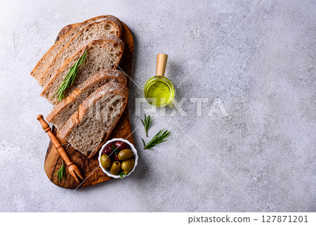 Fresh bread, olive oil and mix of olives. 127871201