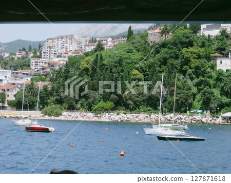 Scenic View of Herceg Novi Beach With Boats in the Tranquil Waters of Boka Kotorska Bay 127871618