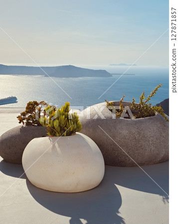 Original and unique flower pots with succulents on a Santorini balcony with a stunning sea view 127871857