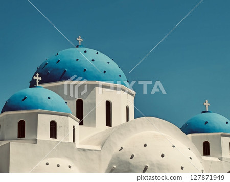 Incredibly beautiful Church of the Holy Cross in Santorini with traditional blue domes 127871949