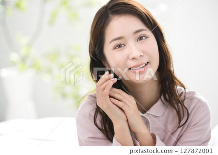 Young woman relaxing in pajamas Young woman relaxing in pajamas 127872001