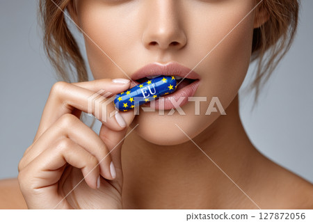 Conceptual depiction of eu influence on freedom with eu-branded tablet, lips of woman and pill Conceptual depiction of eu influence on freedom with eu-branded tablet, lips of woman and pill 127872056