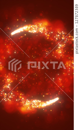 Fiery abstract ring with glowing orange and red particles against a vibrant dark red backdrop 127872389