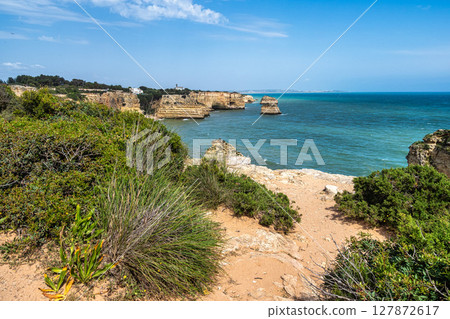 Praia da Marinha Beach among rock islets and cliffs seen from Seven Hanging Valleys Trail, Algarve, Portugal Praia da Marinha Beach among rock islets and cliffs seen from Seven Hanging Valleys Trail, Algarve, Portugal 127872617