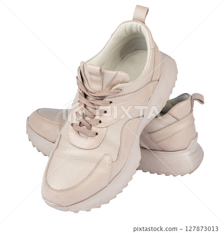 Women's leather sneakers isolated on white background. Women's leather sneakers isolated on white background. 127873013