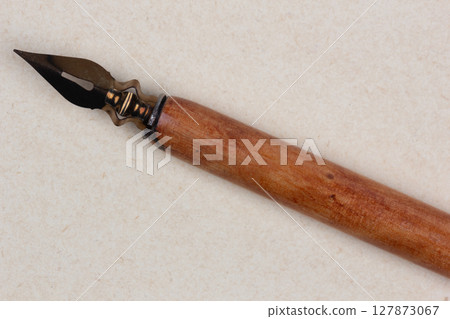 Fountain pen on an antique textured paper. 127873067