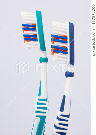 Colored toothbrushes. Isolated on white background. Colored toothbrushes. Isolated on white background. 127873200
