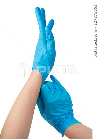 Doctor wearing blue nitrile gloves isolated on white background 127873653