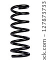 Car spare part. Large metal spring on white background. cushioning spring over white background, auto spare parts. automotive suspension springs on a white background 127873733