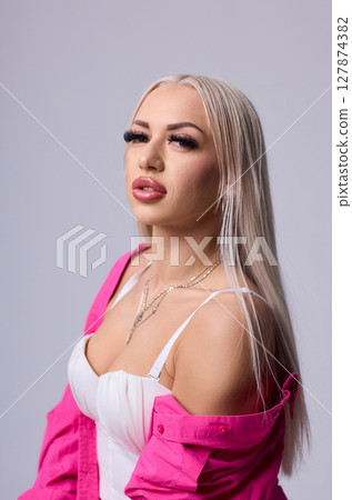 A Stylish Model is Posing Elegantly in a Trendy and Fashionable Outfit for the Camera A Stylish Model is Posing Elegantly in a Trendy and Fashionable Outfit for the Camera 127874382