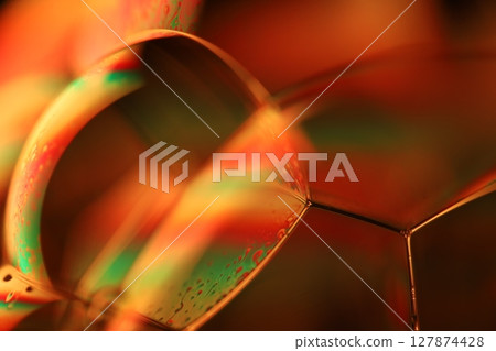 Orange coloured liquid surface, fluid effect, bright chemistry Orange coloured liquid surface, fluid effect, bright chemistry 127874428