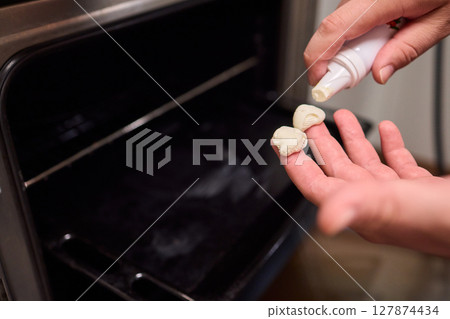 man applying healing cream onto burned hand indoors, closeup man applying healing cream onto burned hand indoors, closeup 127874434