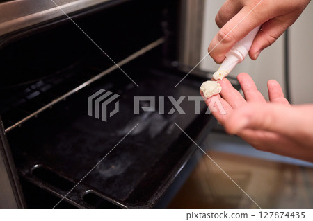 man applying healing cream onto burned hand indoors, closeup man applying healing cream onto burned hand indoors, closeup 127874435