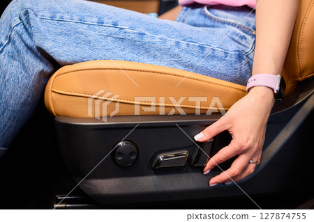 Positioning car seat by hand for optimal comfort and ergonomic support while driving 127874755