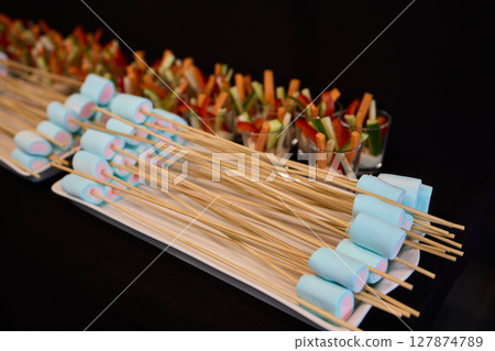 A Vibrantly Colorful Appetizer Platter Featuring Skewers and a Variety of Fresh Ingredients 127874789
