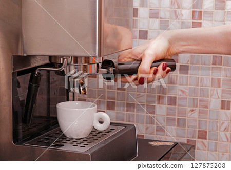 Making espresso on coffee machine Making espresso on coffee machine 127875208