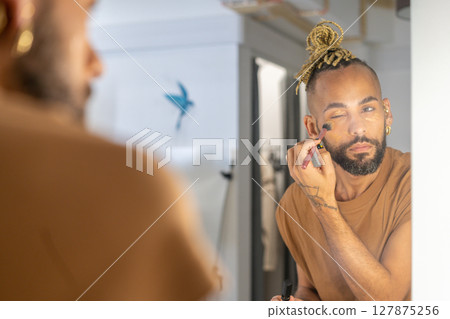 Brazilian Gay Man Applying Makeup Brazilian Gay Man Applying Makeup 127875256