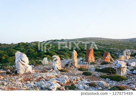 The rocks turn orange in the setting sun 127875489