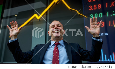 A businessman beams with joy as stock prices soar, profits rise, and an upward arrow on the chart signals success 127875815