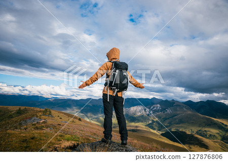 Woman hiker meditation on the high altitude mountain top grassland Woman hiker meditation on the high altitude mountain top grassland 127876806